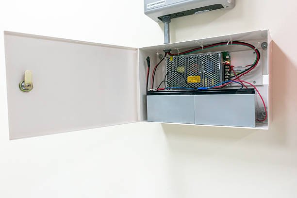 This image features an open electrical control panel displaying various components and wiring inside. Ideal for illustrating electrical systems and maintenance processes.